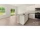 Modern kitchen with granite countertops, stainless steel appliances, and a sliding glass door at 102 Lightning Dr, Shelby, NC 28152