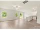 Bright open-plan living area featuring wood floors, a ceiling fan, and an adjacent kitchen area at 102 Lightning Dr, Shelby, NC 28152
