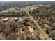 Aerial view showing the home with pool, large drive, and location in the neighborhood at 104 N Hawthorne St, Mount Holly, NC 28120
