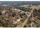 Aerial view showing the location of the home with its pool and large drive within the neighborhood at 104 N Hawthorne St, Mount Holly, NC 28120