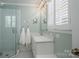 Bright bathroom featuring a glass shower, white vanity, and hexagon tile flooring at 104 N Hawthorne St, Mount Holly, NC 28120