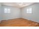 The bedroom features hardwood floors, shuttered windows, and neutral wall paint at 104 N Hawthorne St, Mount Holly, NC 28120
