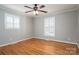 Bedroom featuring hardwood floors, neutral walls, and shuttered windows at 104 N Hawthorne St, Mount Holly, NC 28120