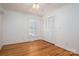 Bedroom featuring hardwood floors, shuttered window and double closets at 104 N Hawthorne St, Mount Holly, NC 28120