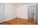 Bedroom featuring hardwood floors, neutral walls and an ensuite door at 104 N Hawthorne St, Mount Holly, NC 28120