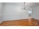 Dining room with hardwood floors, chandelier, and wainscoting at 104 N Hawthorne St, Mount Holly, NC 28120