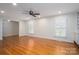 Bright living room featuring hardwood floors, shutters, and an open layout at 104 N Hawthorne St, Mount Holly, NC 28120