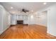 Spacious living room featuring hardwood floors, custom built-ins, and a brick fireplace at 104 N Hawthorne St, Mount Holly, NC 28120