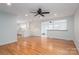 Spacious living room with hardwood floors, white walls and ceiling fan open to the kitchen at 104 N Hawthorne St, Mount Holly, NC 28120
