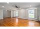 Bright living room featuring hardwood floors, shutters, and an open layout at 104 N Hawthorne St, Mount Holly, NC 28120