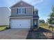 Two-story home featuring a clean two-car garage, neutral siding, and well-kept landscaping at 108 Lightning Dr, Shelby, NC 28152