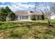 A spacious backyard with lush green grass and mature trees behind the house at 10829 Carmody Ct, Charlotte, NC 28277
