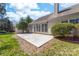A backyard featuring a concrete patio, well-manicured lawn, and mature landscaping at 10829 Carmody Ct, Charlotte, NC 28277