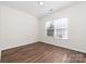 Bedroom with hard wood floors and a large window for natural light at 10829 Carmody Ct, Charlotte, NC 28277
