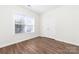 Bedroom featuring hardwood floors, a window for natural light, and a closet for storage at 10829 Carmody Ct, Charlotte, NC 28277