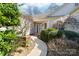 Inviting front entrance with a well-manicured walkway and blossoming plants at 10829 Carmody Ct, Charlotte, NC 28277
