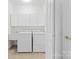 Clean and tidy laundry room with washer, dryer and utility sink. Ample storage at 10829 Carmody Ct, Charlotte, NC 28277