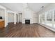 Living room featuring a fireplace, a ceiling fan and a large window that brings in natural light at 10829 Carmody Ct, Charlotte, NC 28277