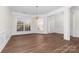Open living space with hardwood floors, decorative molding, and a chandelier at 10829 Carmody Ct, Charlotte, NC 28277