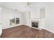Bright living room with a fireplace and large window letting in natural light and the ceiling fan for those hot days at 10829 Carmody Ct, Charlotte, NC 28277