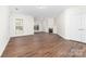 Open living room features a fireplace, large window, and wood floors, creating a comfortable and inviting space at 10829 Carmody Ct, Charlotte, NC 28277