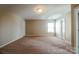 Carpeted bedroom with neutral walls, one window, and two doors at 10943 Trout Creek Pl, Davidson, NC 28036