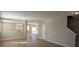 Spacious living room featuring an open floor plan, wood floors, natural light, a fireplace, and access to the backyard at 10943 Trout Creek Pl, Davidson, NC 28036