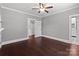 Bedroom with hardwood floors and access to the hall and bathroom at 1135 Old Charlotte Rd, Concord, NC 28027