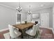 Dining room with table and chairs, chandeliers, and neutral paint color at 1135 Old Charlotte Rd, Concord, NC 28027