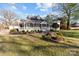 Charming home with a well-manicured lawn, landscaping, and inviting front porch at 1135 Old Charlotte Rd, Concord, NC 28027