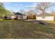 Charming home with inviting front porch, detached garage, and partially wooded lot at 1135 Old Charlotte Rd, Concord, NC 28027