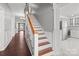 Staircase leading to the upper level with hardwood floors and white railings at 1135 Old Charlotte Rd, Concord, NC 28027