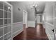 Hallway with hardwood floors, wall paneling, and chandelier lighting at 1135 Old Charlotte Rd, Concord, NC 28027