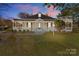 Charming home featuring a cozy porch and a well-maintained front yard at 1135 Old Charlotte Rd, Concord, NC 28027