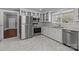 Bright kitchen with stainless steel appliances, white cabinets, and marble flooring at 1135 Old Charlotte Rd, Concord, NC 28027