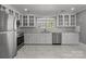 Bright kitchen with stainless steel appliances, white cabinets, and marble flooring at 1135 Old Charlotte Rd, Concord, NC 28027