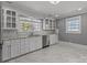 Bright kitchen with white cabinets, granite countertops, and marble floors at 1135 Old Charlotte Rd, Concord, NC 28027