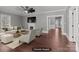 Virtually staged living room with a fireplace, stylish furniture, and hardwood floors at 1135 Old Charlotte Rd, Concord, NC 28027