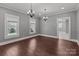 Spacious living room with hardwood floors, elegant chandeliers, and natural light at 1135 Old Charlotte Rd, Concord, NC 28027