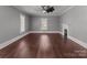 Spacious living room with a fireplace, hardwood floors, and large windows at 1135 Old Charlotte Rd, Concord, NC 28027
