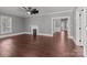 Open living room with hardwood floors, a fireplace, and natural light at 1135 Old Charlotte Rd, Concord, NC 28027