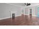 Bright living room featuring hardwood floors, a fireplace, and views into the next rooms at 1135 Old Charlotte Rd, Concord, NC 28027