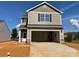 Two-story home boasts a large two-car garage, neutral siding, a covered porch, and an unfinished front yard at 119 Lightning Dr, Shelby, NC 28152