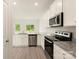 Well-appointed kitchen with stainless steel appliances and white cabinets and granite countertops at 119 Lightning Dr, Shelby, NC 28152