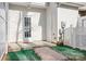 Backyard with white doors, white fence, artificial grass, and gravel at 12417 Mcgrath Dr, Charlotte, NC 28269