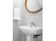 A minimalistic bathroom with a white sink and a round gold-framed mirror at 12417 Mcgrath Dr, Charlotte, NC 28269