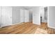 Bedroom with hard wood floors, neutral walls, and views to attached bathroom and closet at 12417 Mcgrath Dr, Charlotte, NC 28269