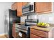 Kitchen featuring granite countertops, stainless steel appliances, and modern cabinetry, creating a functional space at 12417 Mcgrath Dr, Charlotte, NC 28269