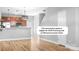 Spacious living room featuring wood floors and an open layout into the kitchen at 12417 Mcgrath Dr, Charlotte, NC 28269
