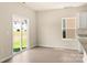 Bright kitchen area with sliding glass doors and adjacent stainless steel refrigerator at 125 Lightning Dr, Shelby, NC 28152
